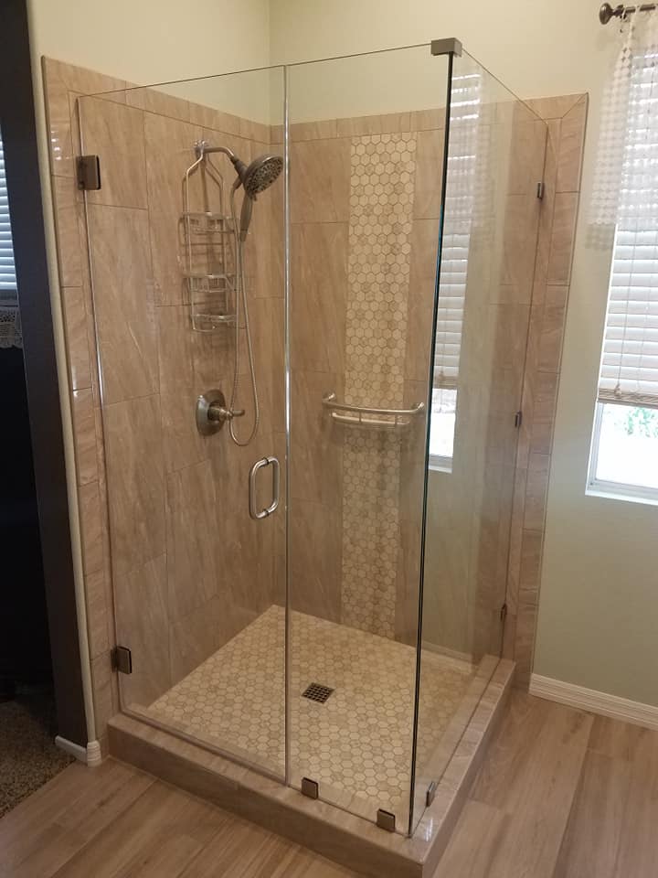 Finished accessible shower with glass enclosure and grab bar