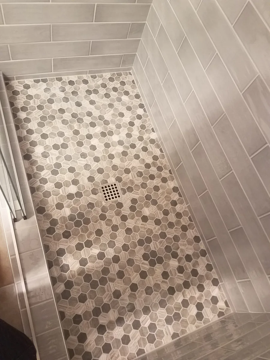 Hexagon tile shower pan with grey wall tile