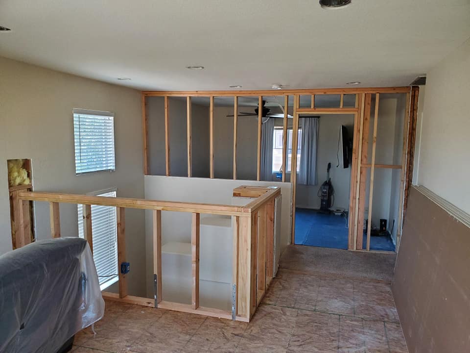 Loft addition framed with a railing above the living room in Temecula