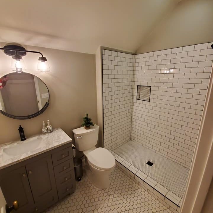 Finished walk-in shower with tiled pan and hex floor tile